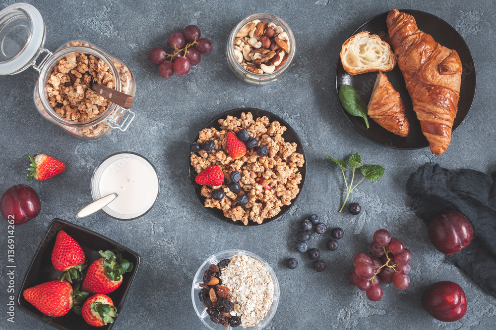 Healthy breakfast with muesli, fruits, berries, nuts on grunge background. Flat lay, top view Healthy breakfast with muesli, fruits, berries, nuts on grunge background. Flat lay, top view