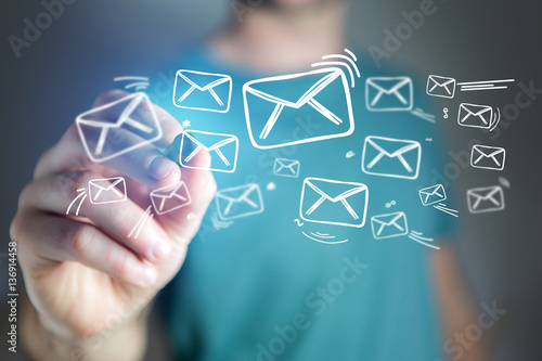 Concept of man drawing email icon on technology interface