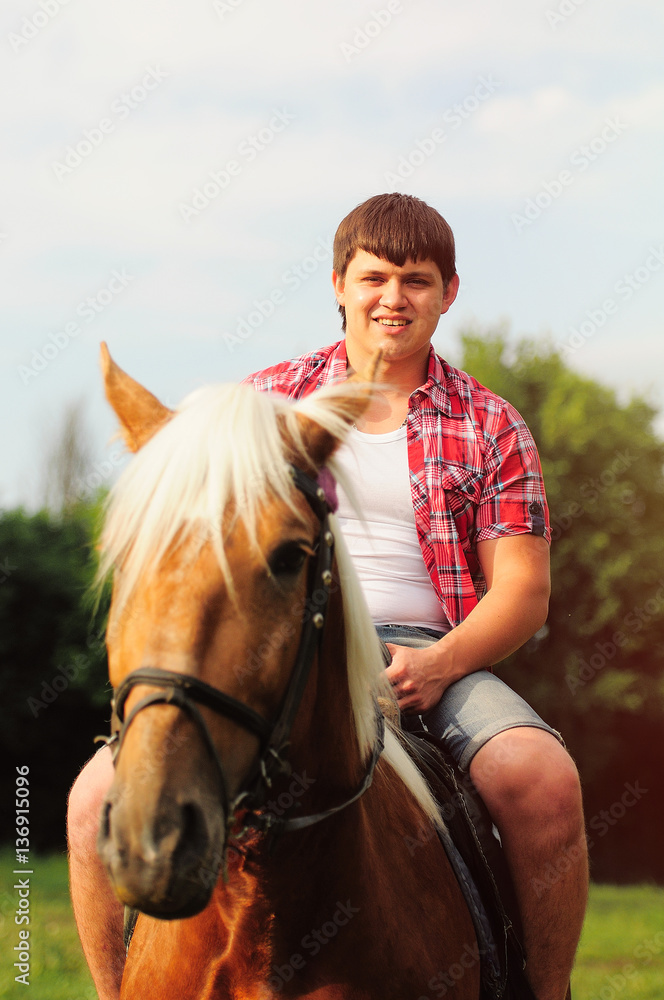 Obraz premium young in shape man on a horse