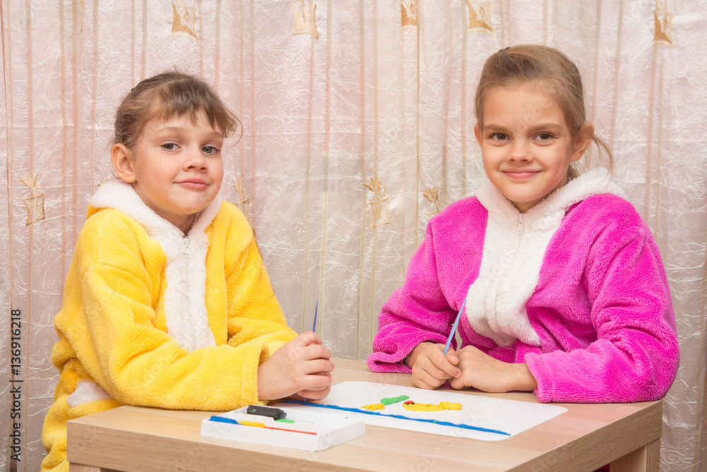 Two sisters five and seven years together molded from clay crafts, and looked into the frame Two sisters five and seven years together molded from clay crafts, and looked into the frame