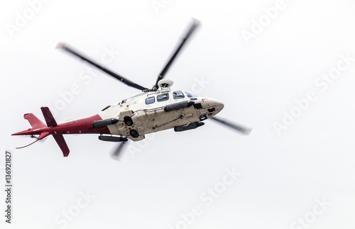 Airborn Helicopter Isolated Against White Overcast Sky
