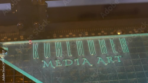 Lasercutter cutting out logo