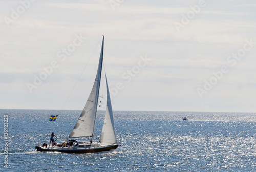 Sailboat on the glittering blue sea