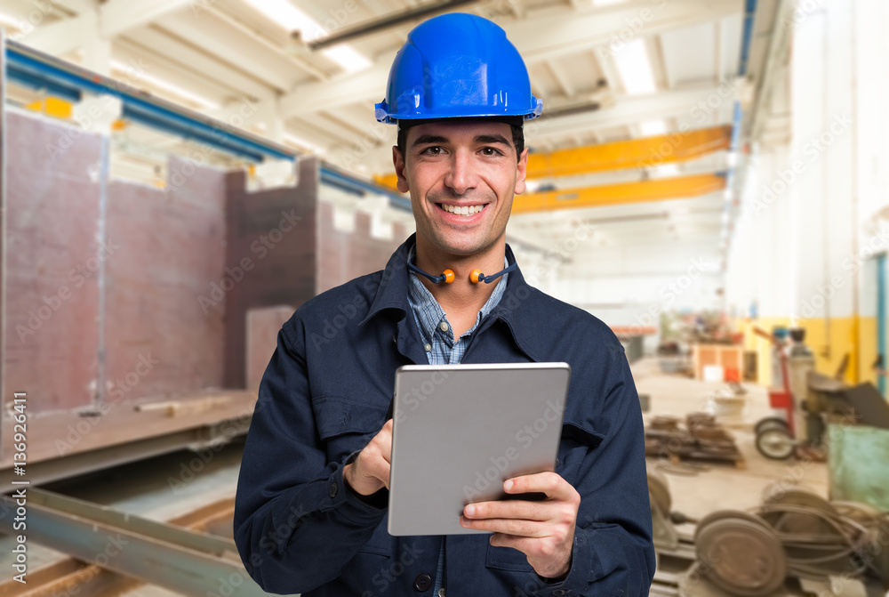 Smiling engineer using a tablet Smiling engineer using a tablet