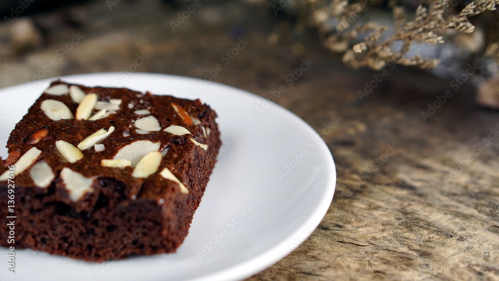 Sweet chocolate brownies put on a wood table with dark roasting coffee beans. Sweet chocolate brownies put on a wood table with dark roasting coffee beans.