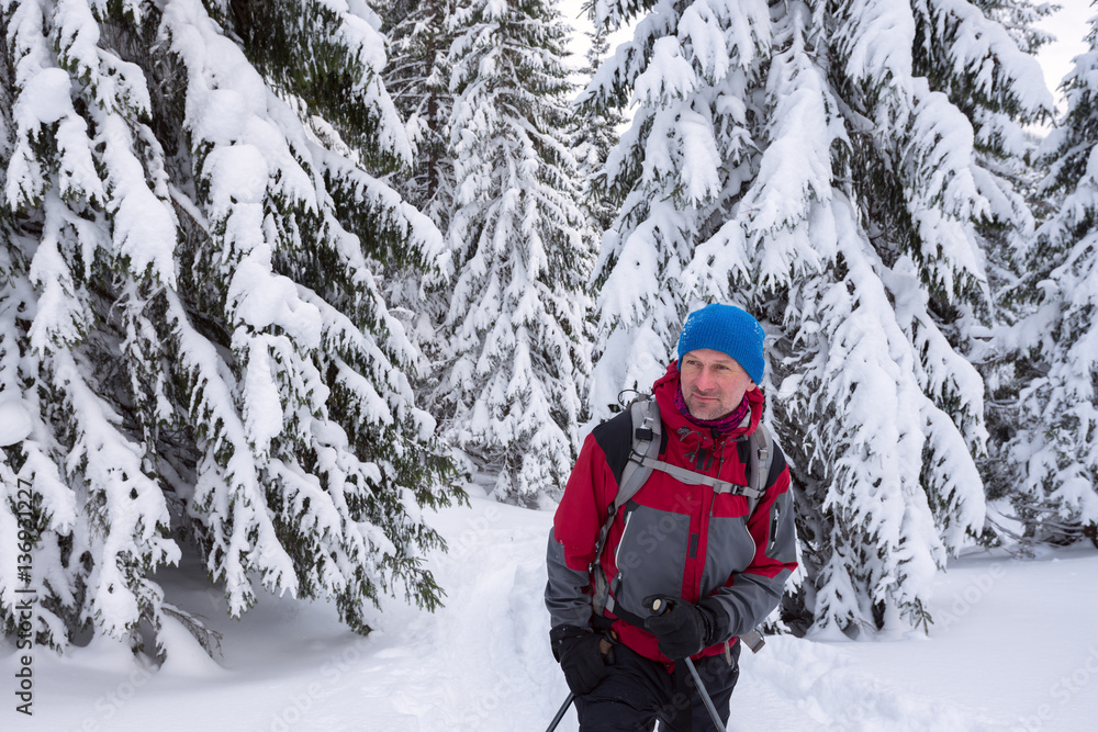 Traveler man enjoying a wonderful adventure in the winter mounta