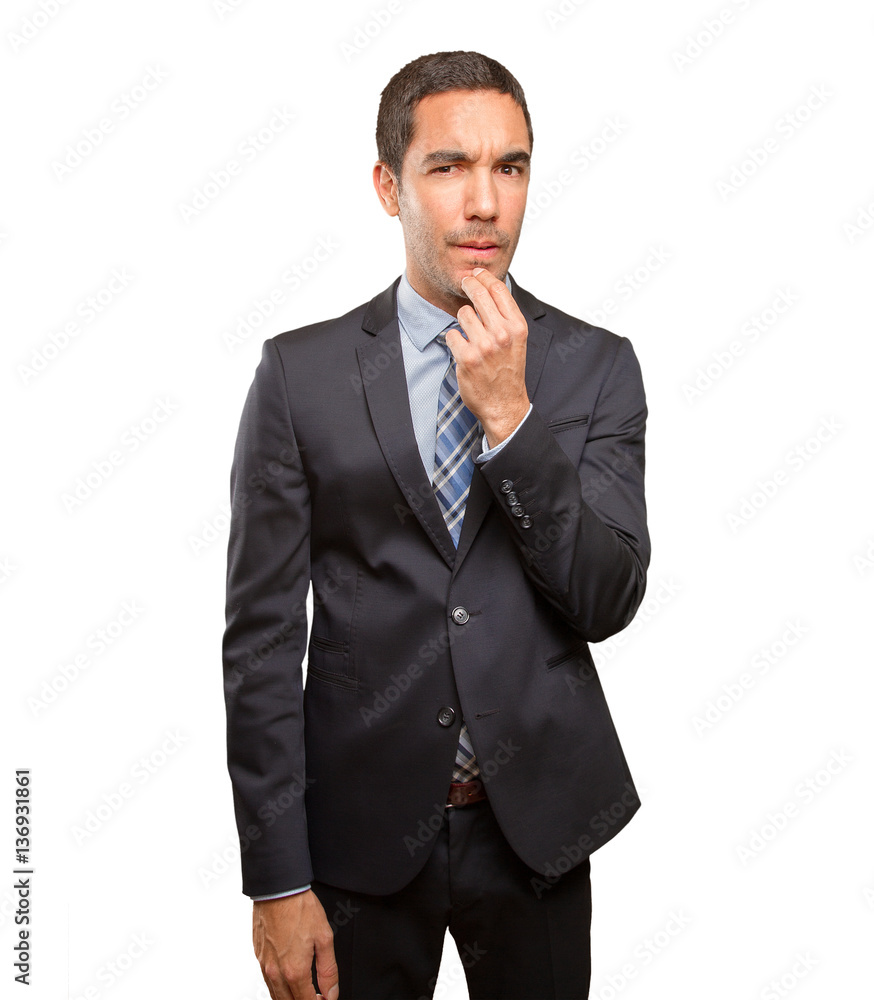 Doubtful young businessman doing a distrust gesture Doubtful young businessman doing a distrust gesture