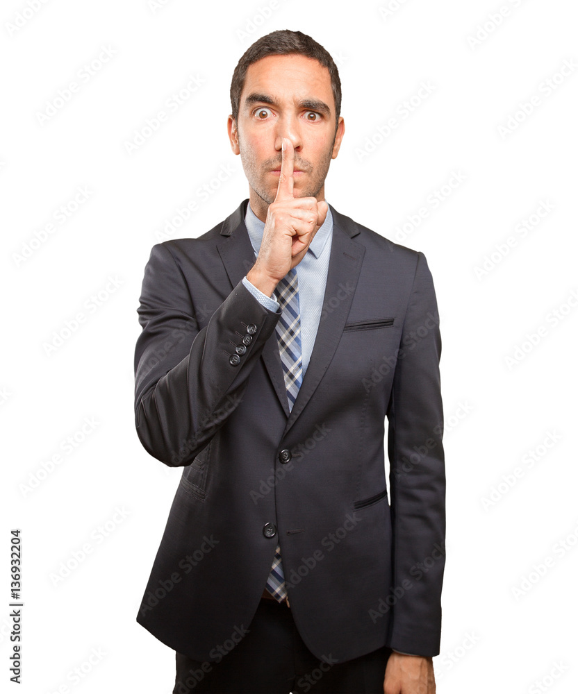 Worried young man asking for silence Worried young man asking for silence