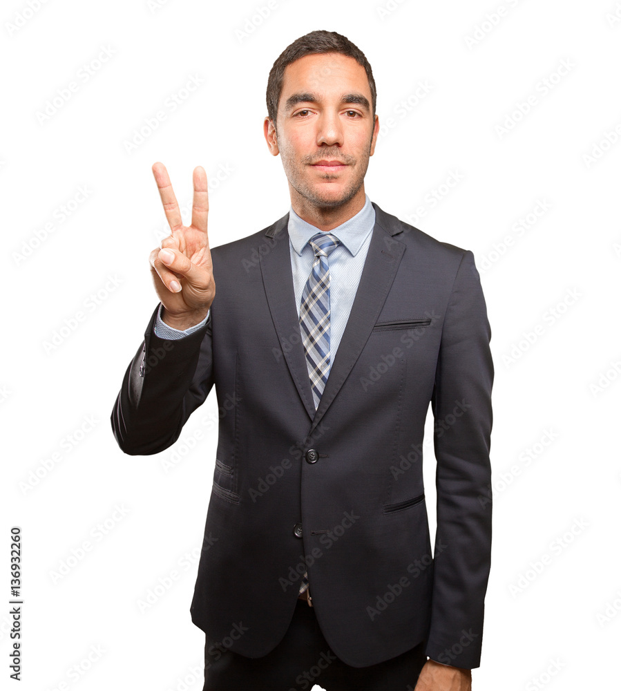 Happy young businessman doing a victory gesture Happy young businessman doing a victory gesture