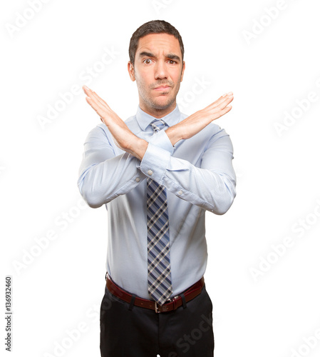 Fotografie Serious young businessman doing a prohibition gesture