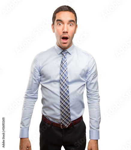 Surprised young businessman posing