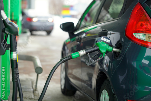 Car refueling on a petrol station in winter © vladstar