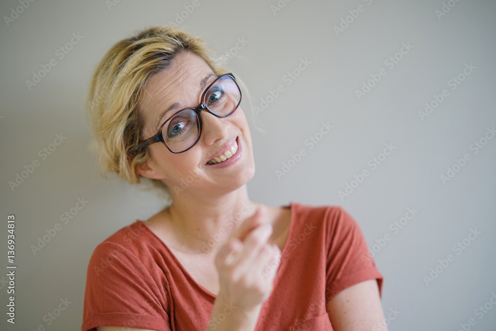 Smiling blond woman with eyeglasses and red shirt, isolated Smiling blond woman with eyeglasses and red shirt, isolated