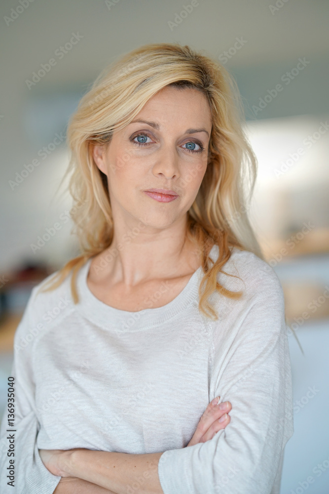 Fototapeta premium portrait of cheerful middle-aged blond woman