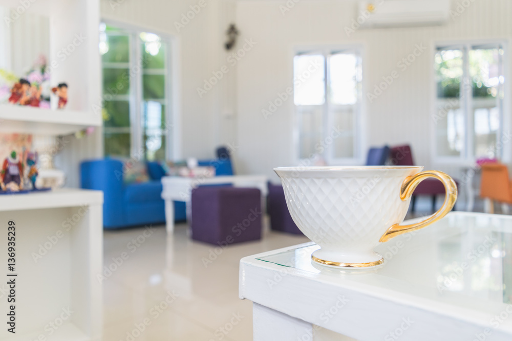 White cup of coffee on wooden table in the coffee shop. White cup of coffee on wooden table in the coffee shop.