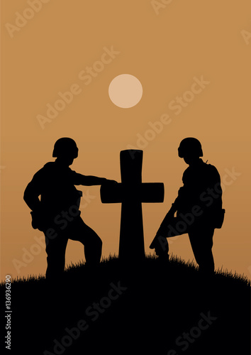 Two soldiers near the old grave with a cross.