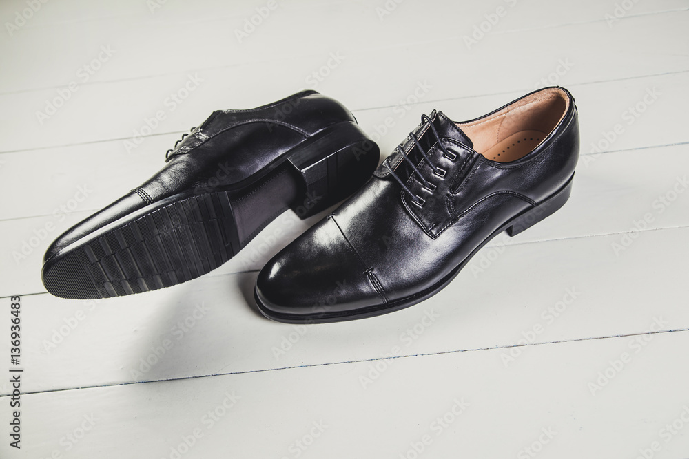 Black men's leather shoes on a white board Black men's leather shoes on a white board