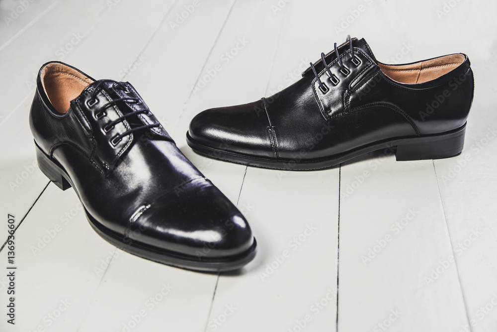 Black men's leather shoes on a white board Black men's leather shoes on a white board