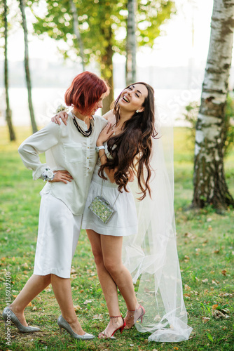 Two friends girls having fun on park at hen party.