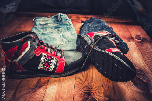 men's clothing, red sneakers on a wooden background,