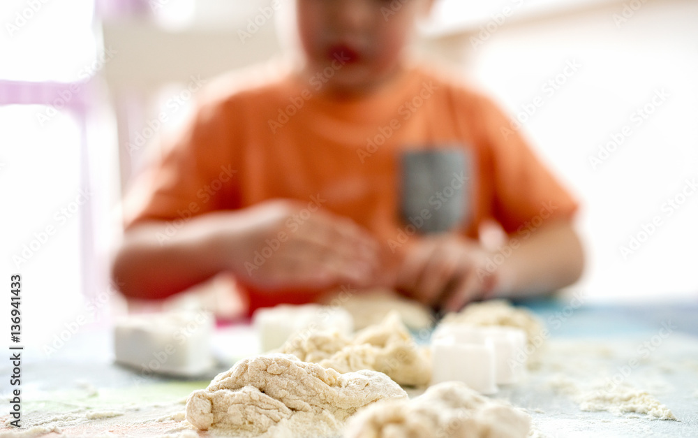 Dough. Kid enjoying making it. Dough. Kid enjoying making it.