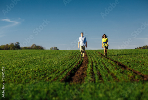 Couple in love walking along the field