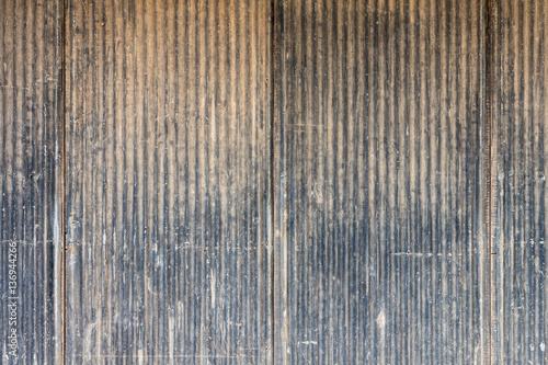 Old scratched metal wall. It is made of corrugated iron sheet.