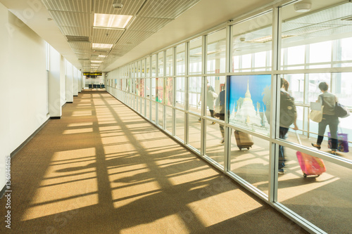 Slika na platnu Passengers walking on walkway to airplane