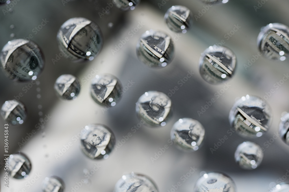 money, dollars reflected in a drop of water money, dollars reflected in a drop of water
