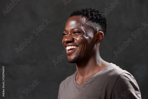 young african american man laughing and looking away
