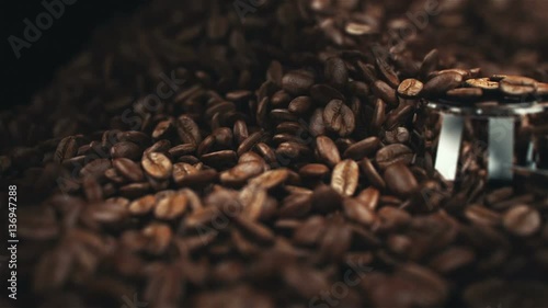 Coffee beans in the grinder. High quality super slow motion coffee beans in the grinder photo