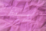 Closeup empty pink crumled fabric wrinkles background
