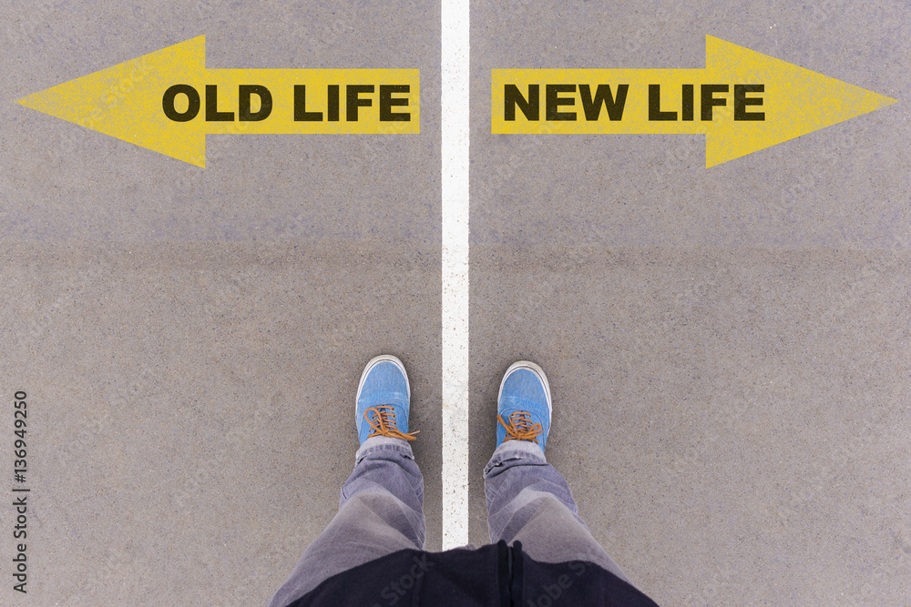 Old vs new life text arrows on asphalt ground, feet and shoes on