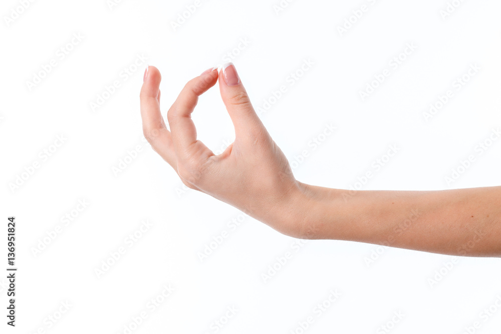 female hand outstretched to the side and showing the gesture with two fingers clasped female hand outstretched to the side and showing the gesture with two fingers clasped