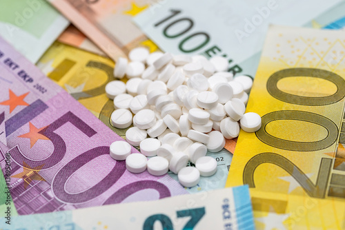different pills above euros bills. close up.
