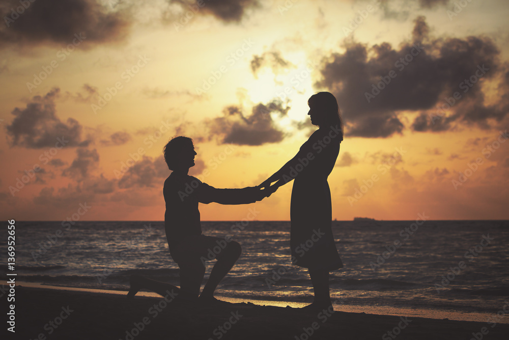 Marriage proposal at sunset beach