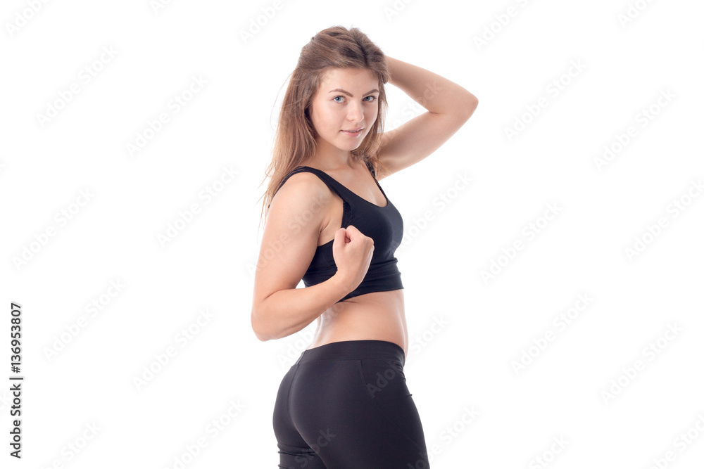 young athletic girl in black clothes is worth turning sideways and kept the ball for hair isolated on white background young athletic girl in black clothes is worth turning sideways and kept the ball for hair isolated on white background