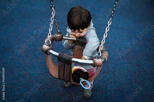 Niño jugando solo en el parque photo