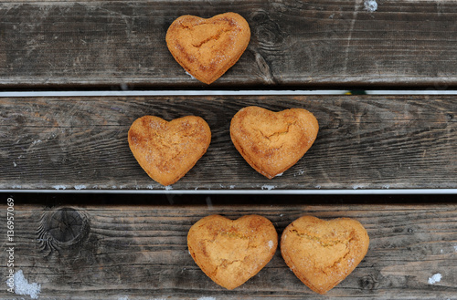 Homemade cookies with cinnamon over wooden background