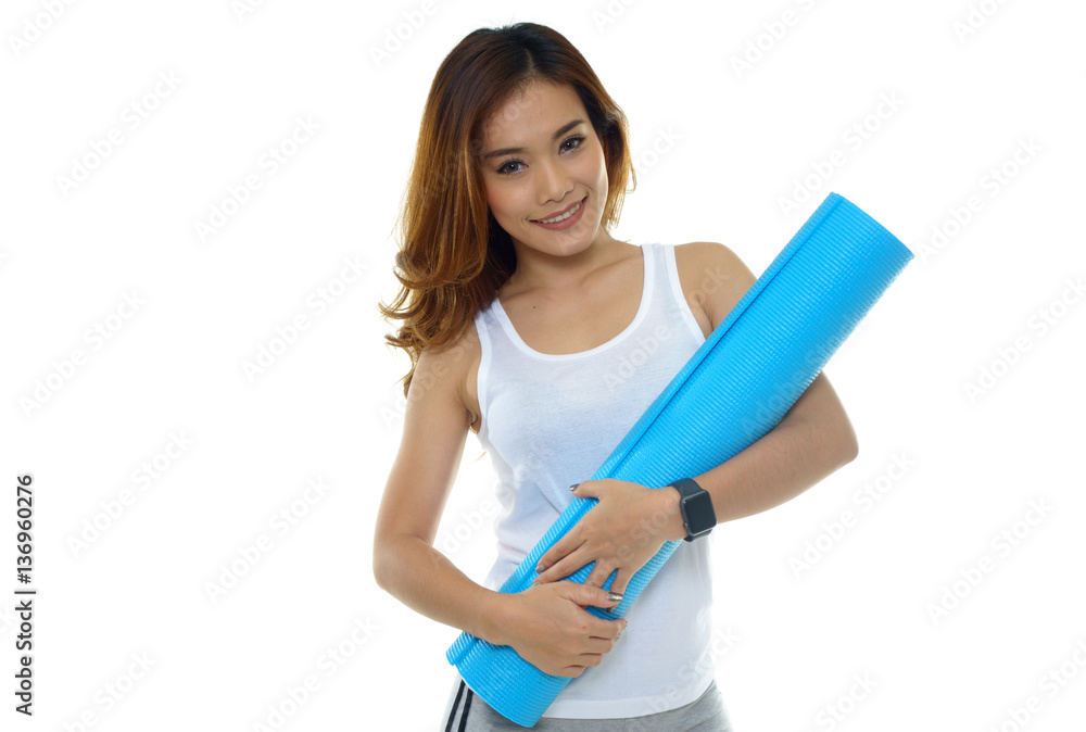Young woman holding a yoga mat on white background Young woman holding a yoga mat on white background