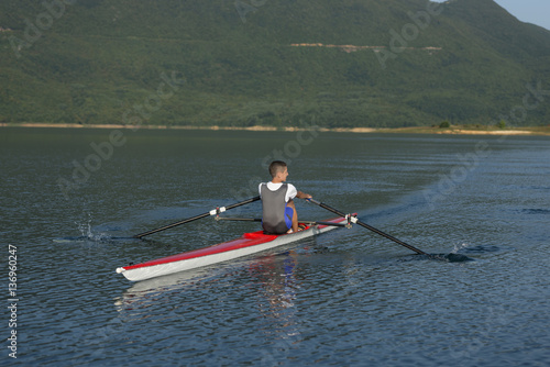 Child in the course of rowing on single