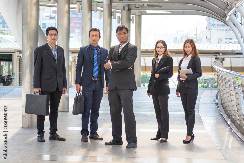 Smiling and Confident Asian Business Team Standing in Modern Cit