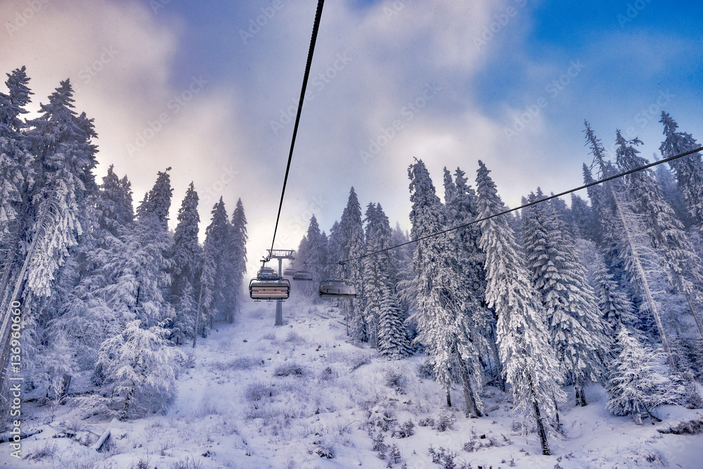 Winter mountains panorama with ski slopes and ski lifts