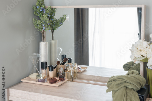 Beauty and make-up concept: table mirror, flowers, perfume, jewe photo