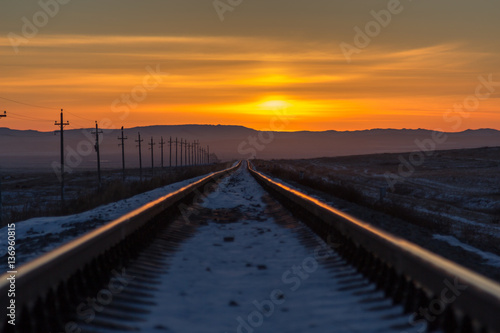 Railway receding into the distance at sunrise © cherniyvg