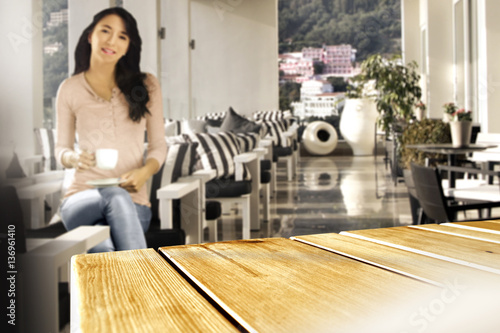 woman with coffee and wooden desk space 