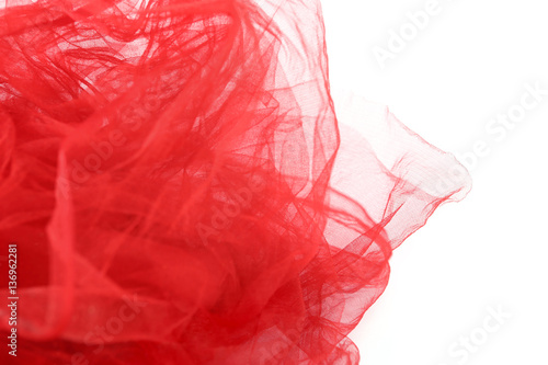 Red tulle fabric background. Abstract transparent material curve wave on white.