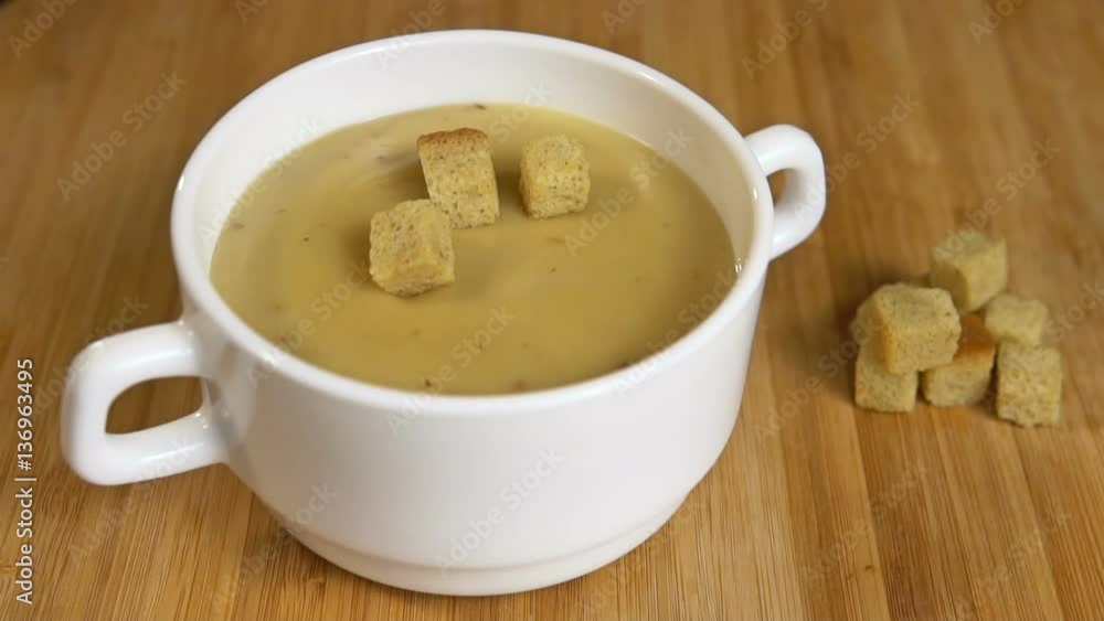 crouton fall in mushroom cream soup Slow motion crouton fall in mushroom cream soup Slow motion