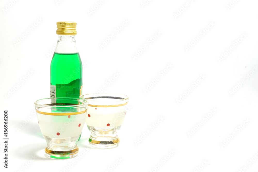 Small bottle of mint liqueur with two shot glasses Small bottle of mint liqueur with two shot glasses