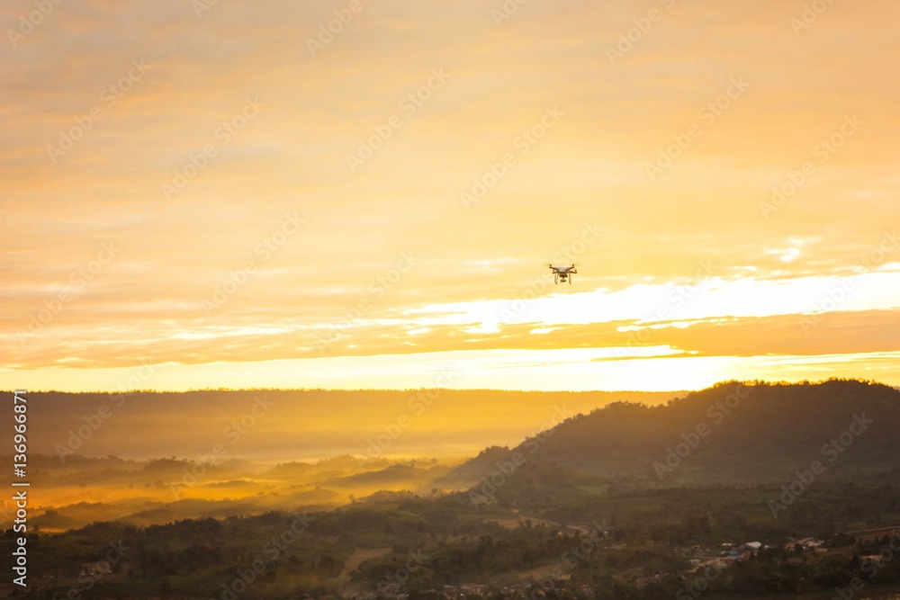 Obraz premium Beautiful sunset with drone over range and village